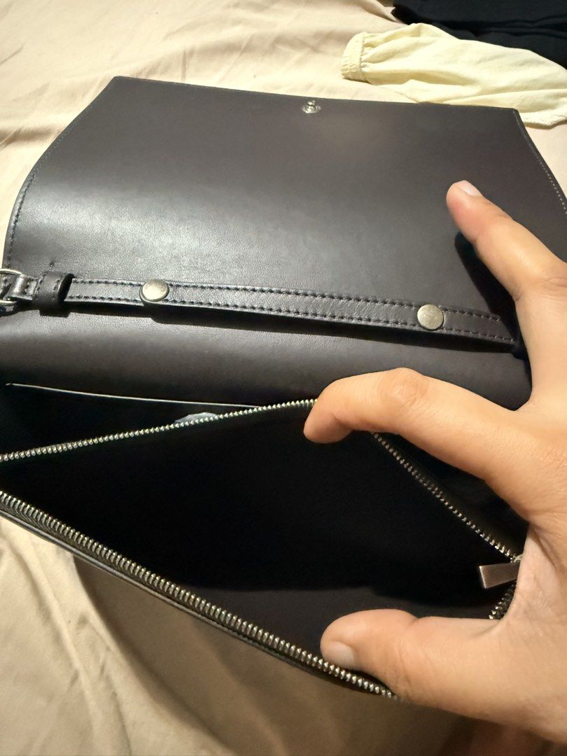 Celine Paris Leather Clutch Bag with Chain (Category: Luxury Bags & Wallets) located in Manila. Submitted by gemini_89 (Listing ID 1458016456, Image 3). Description: - Original Celine Paris clutch bag - Material: Dark grey leather with a light pink front flap - Interior: Zip compartment and card slots - Strap: Detachable silver chain strap - Origin: Made in Italy - Perfect for: Evening events or as a statement accessory.