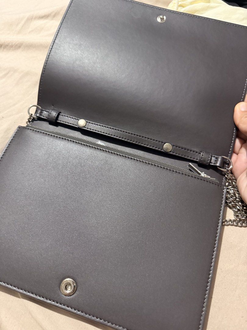 Celine Paris Leather Clutch Bag with Chain (Category: Luxury Bags & Wallets) located in Manila. Submitted by gemini_89 (Listing ID 1458016456, Image 2). Description: - Original Celine Paris clutch bag - Material: Dark grey leather with a light pink front flap - Interior: Zip compartment and card slots - Strap: Detachable silver chain strap - Origin: Made in Italy - Perfect for: Evening events or as a statement accessory.