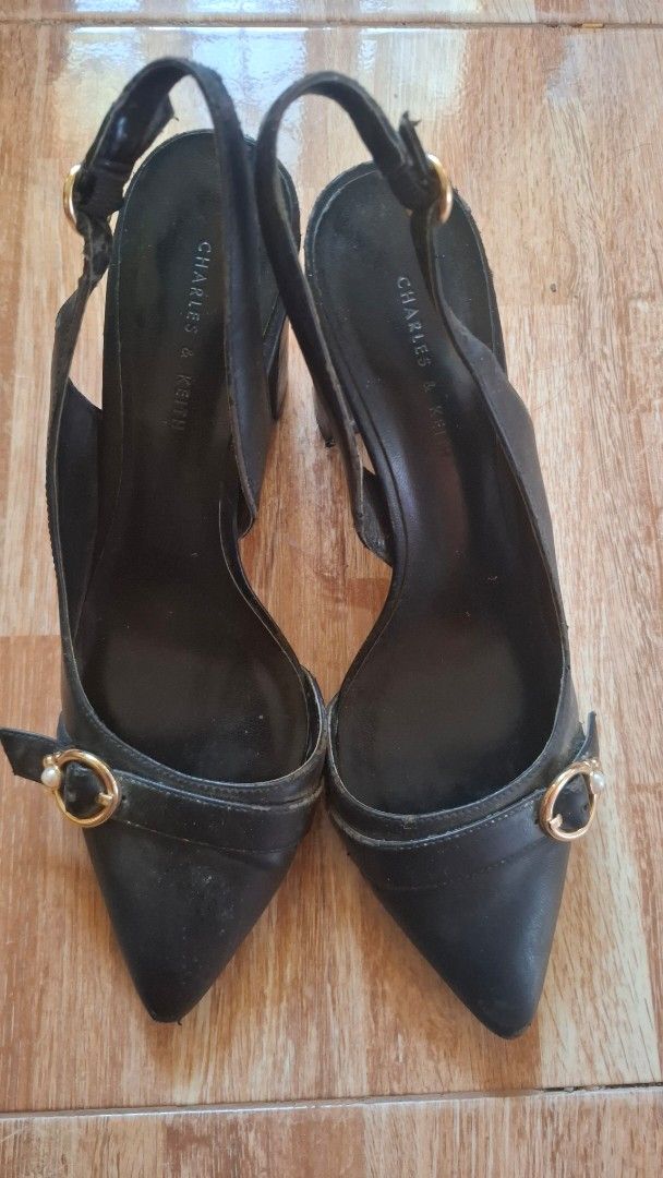 Charles & Keith Black Slingback Heels (Category: Heels) located in Tuguegarao City. Submitted by mondreigon (Listing ID 1457927392, Image 1). Description: size 37 pre loved Chic black slingback heels from Charles & Keith. Features a pointed toe, gold buckle with pearl accent, and adjustable slingback strap. Shows some wear on soles and heels..