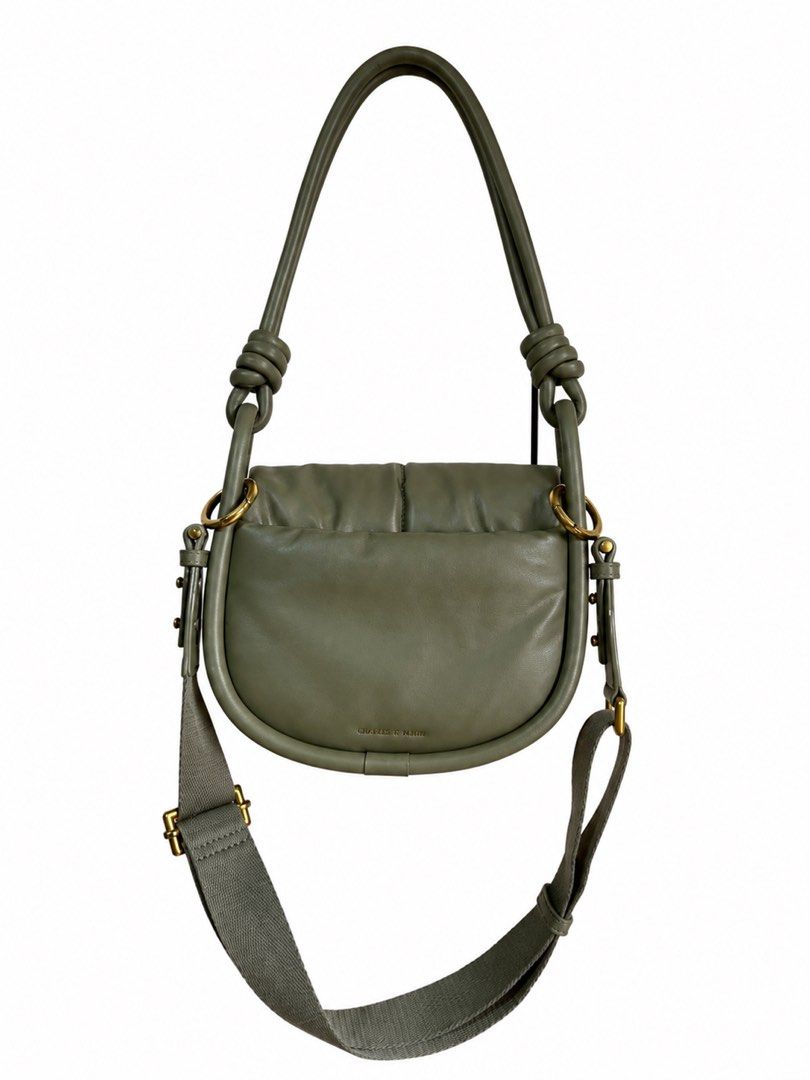 Charles & Keith Olive Green Knot Handle Shoulder Bag (Category: Shoulder Bags) located in Bacoor. Submitted by sofaritsalright (Listing ID 1457973462, Image 2). Description: - Bought for 3859 - Olive green shoulder bag from Charles & Keith. - Features a stylish knotted handle. - Includes a detachable strap for versatility. - Chic curved shape with subtle front stitching. - Brand name embossed on the front. - Ideal for everyday wear and tear..