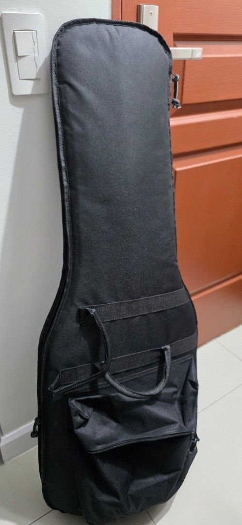 Clean Electric Guitar Gig Bag Soft Case (Category: Musical Instruments) located in Taguig. Submitted by cze.g (Listing ID 1458073034, Image 1). Description: - Fairly new and clean Black electric guitar gig bag - no brand - generic gig bag from Japan. - Thick internal padding - external velcro padding with option to attach more padding - Soft case design - Very durable material - Large front pocket for accessories. Fits pedals and cables. - Includ