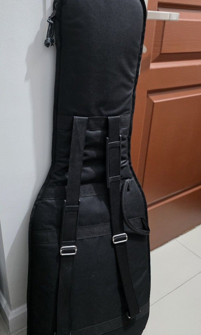 Clean Electric Guitar Gig Bag Soft Case (Category: Musical Instruments) located in Taguig. Submitted by cze.g (Listing ID 1458073034, Image 2). Description: - Fairly new and clean Black electric guitar gig bag - no brand - generic gig bag from Japan. - Thick internal padding - external velcro padding with option to attach more padding - Soft case design - Very durable material - Large front pocket for accessories. Fits pedals and cables. - Includ