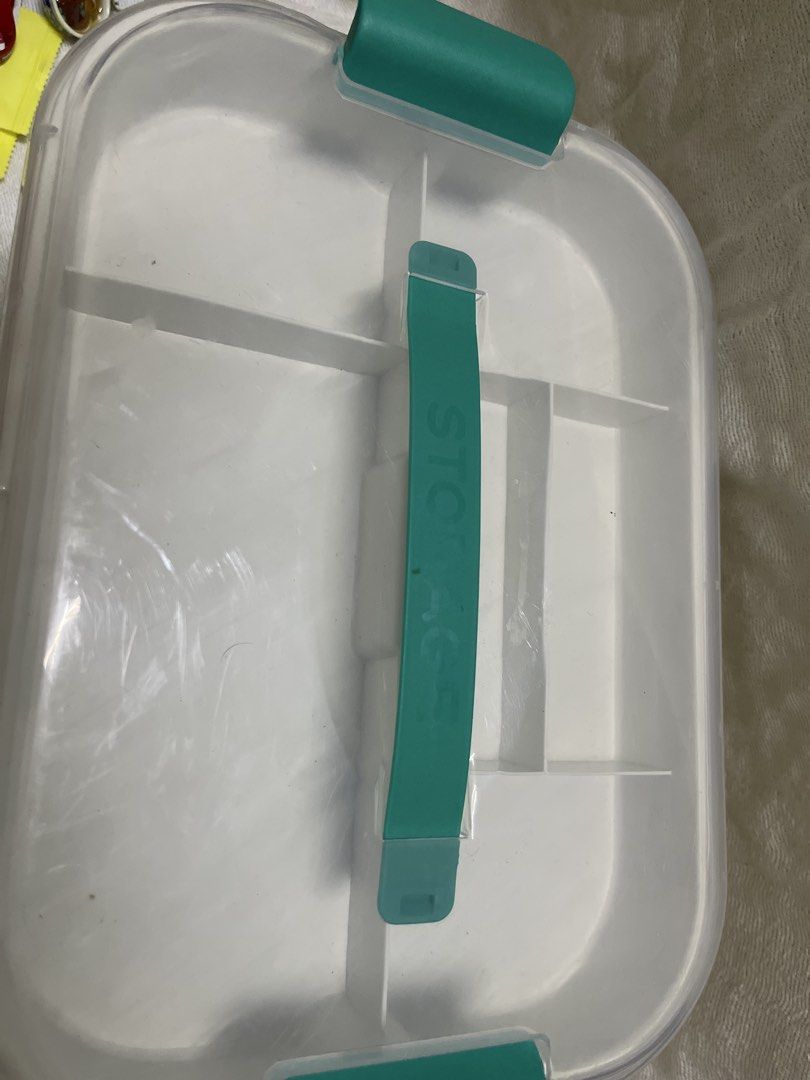 Clear Plastic Storage Box with Teal Handle and Dividers (Category: Storage Boxes & Baskets) located in Manila. Submitted by prima_onda (Listing ID 1457965018, Image 2). Description: - Clear plastic storage box - Teal handle and side clasps - Internal dividers for organization - Clear lid to see contents easily - Ideal for crafts, sewing supplies, or small toys.