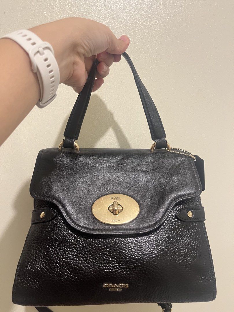 Coach Black Leather Turnlock Satchel Handbag (Category: Luxury Bags & Wallets) located in Taguig. Submitted by wuuuby (Listing ID 1458036526, Image 1). Description: - Genuine black leather Coach handbag - Signature gold turnlock closure on front flap - Versatile carrying options: top handles and detachable crossbody strap - Minor scuffs on hardware and leather, consistent with normal use - Plenty of wear left, ideal for everyday or evening use - 