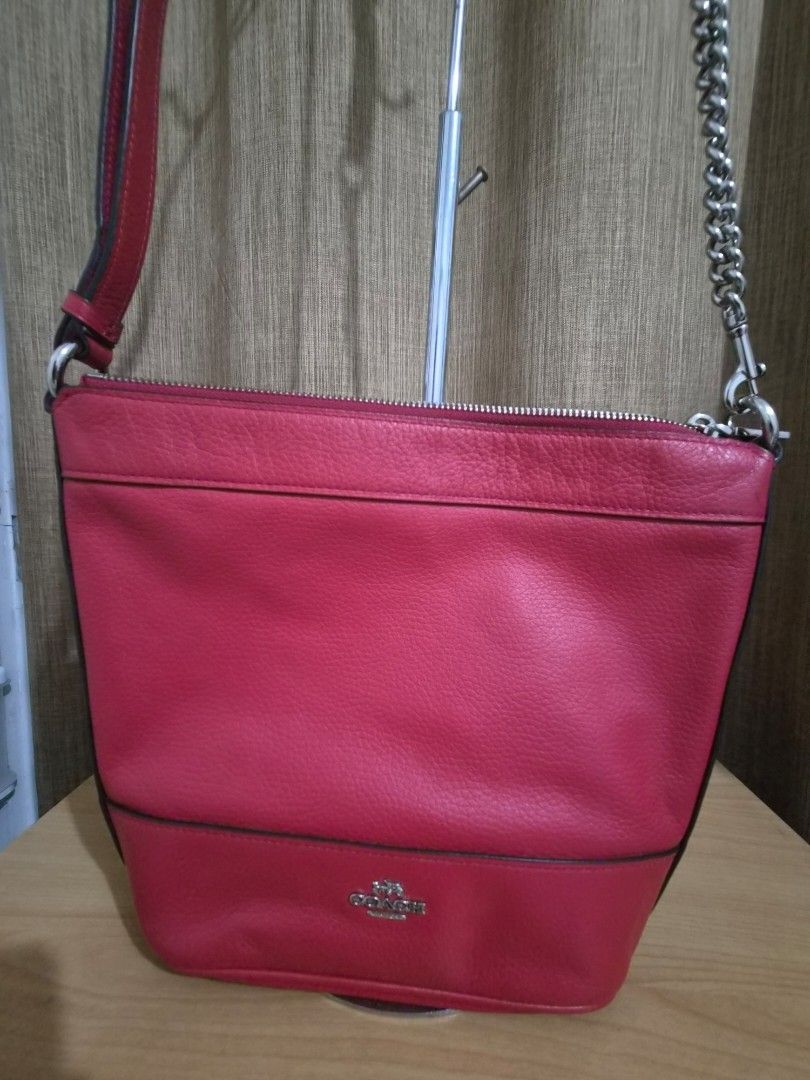 Coach Red Leather Shoulder Bag with Chain Strap (Category: Luxury Bags & Wallets) located in Paranaque City. Submitted by regf_01 (Listing ID 1458078868, Image 2). Description: Preloved 100% authentic chic red leather Coach bag with versatile silver chain and leather straps. Top zipper closure, fabric lining, and interior pocket. Embossed logo. Perfect for daily use! pls see very minimal issue on last pic.