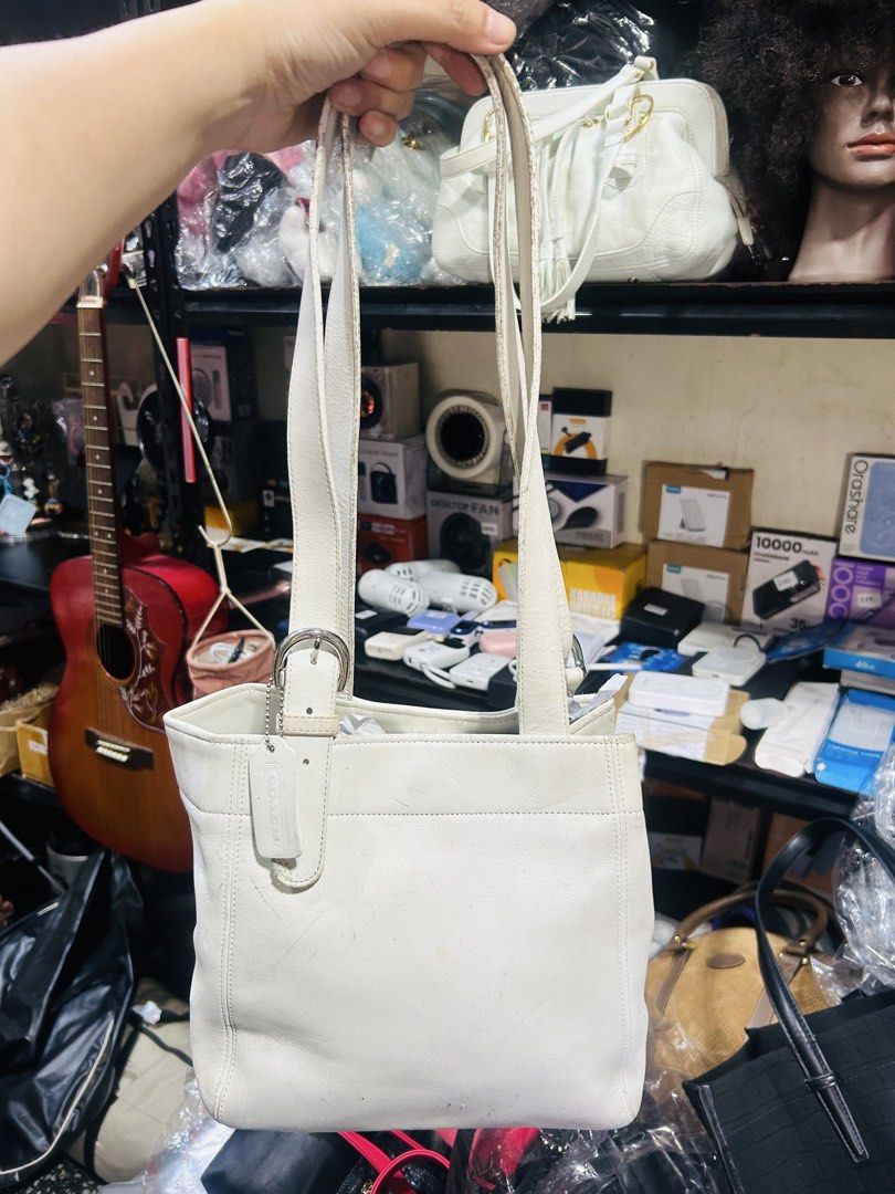 Coach White Leather Tote Bag (Category: Luxury Bags & Wallets) located in Manila. Submitted by starbalesukandjapansurplus (Listing ID 1458003423, Image 1). Description: - Authentic Coach white leather tote bag - Classic and versatile design - Comfortable shoulder straps with buckle detail - Features an interior zip pocket for secure storage - Ideal for everyday wear and carrying essentials.