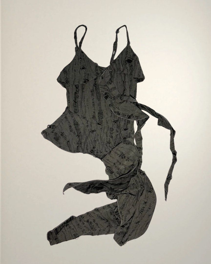 Distressed asymmetrical halter top (Category: Sleeveless) located in Dasmarinas. Submitted by caitswardrobe (Listing ID 1458036299, Image 1). Description: Has adjustable straps, bought this in Vietnam kaso i forgot what brand huhu Length - 14 (doesn't include yung nakalawlaw) Width - 10 .