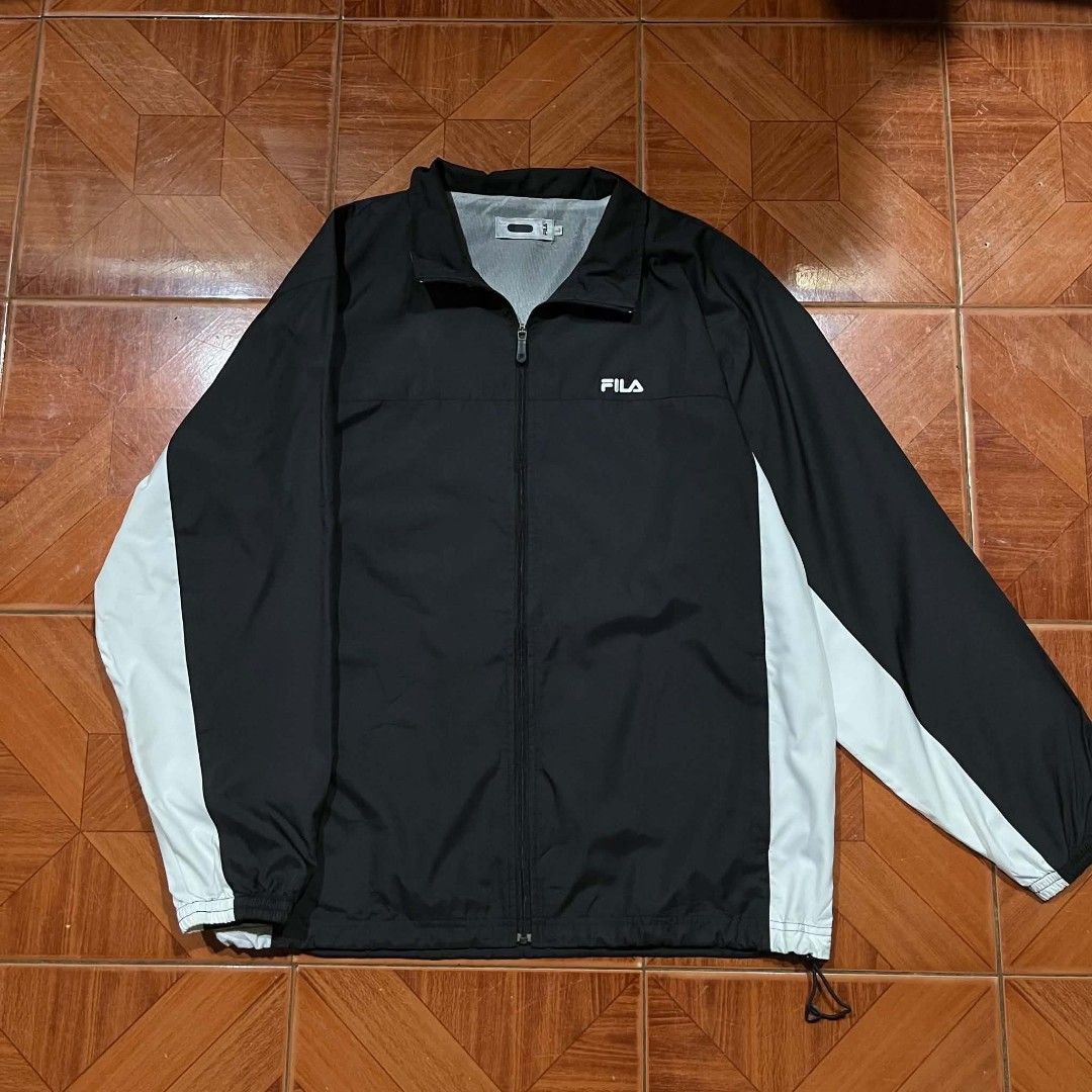 FILA Black & White Light Track Jacket Windbreaker Size L (Category: Coats, Jackets and Outerwear) located in Pasig City. Submitted by mavsthrift (Listing ID 1457945068, Image 1). Description: Classic Fila Windbreaker track jacket - Color: Black with white side panel details - Full zip closure - Drawstring at the hem - Size: L -Condition 8/10 Ship Via J&T, Lalamove or Pickup(Pasig) Payment first No return, no refund policy. .