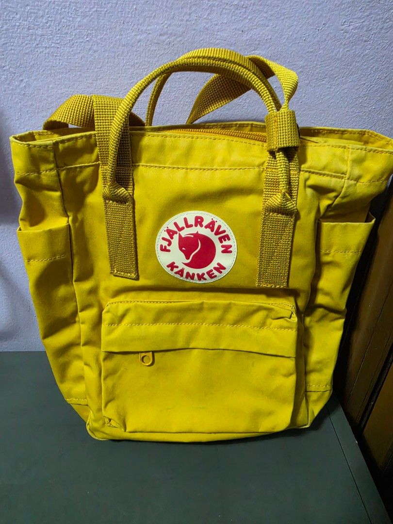 Fjallraven Kanken Mini Totepack Yellow (Category: Backpacks) located in Manila. Submitted by mayanndayang (Listing ID 1458016979, Image 1). Description: - Authentic Yellow Fjallraven Kanken Mini totepack - Iconic logo patch on the front - Two convenient side pockets - Spacious main compartment with zipper closure - Adjustable shoulder straps for comfortable carrying - Dual top handles for alternative carrying options - Interior name tag and a sma