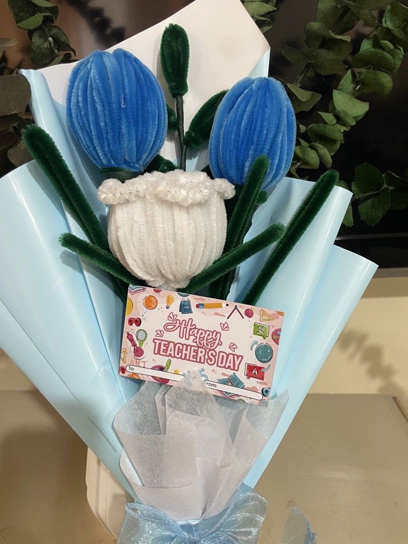 Flower Bouquets (Category: Flowers & Bouquets) located in Rizal. Submitted by arlynazanion16 (Listing ID 1457911540, Image 2). Description: This image shows a handmade fuzzy wire tulip bouquet featuring two blue tulips and one white tulip wrapped in light blue paper with a "Happy Teacher's Day" card..