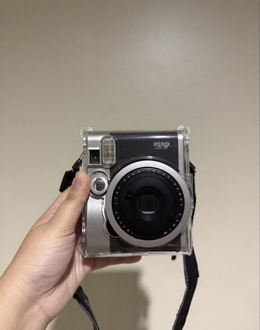Fujifilm Instax Mini 90 Neo Classic Camera (Category: Cameras) located in Mandaluyong City. Submitted by micachuuu (Listing ID 1457982669, Image 1). Description: - Fujifilm Instax Mini 90 Neo Classic camera - Comes with a clear protective case - Includes a strap - Works great and takes awesome instant photos - Ready for your next adventure or fun memories.
