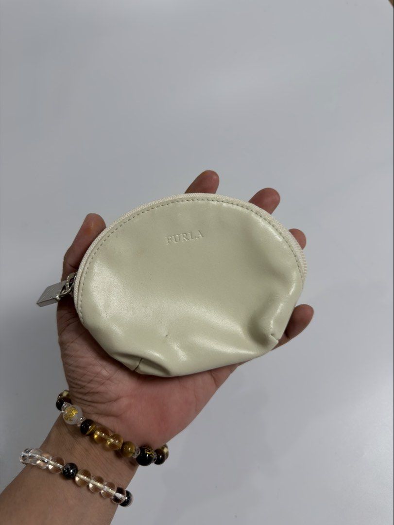 Furla Leather Coin Purse (Category: Luxury Bags & Wallets) located in Alfonso. Submitted by jbcamet (Listing ID 1458009167, Image 2). Description: - Cream colored Furla coin purse - Small and compact design - Perfect for coins or small essentials - Secure zipper closure - Genuine leather material - Shows some signs of wear, but still fully functional.