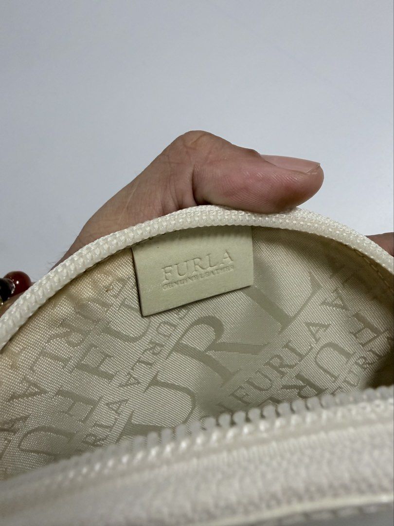 Furla Leather Coin Purse (Category: Luxury Bags & Wallets) located in Alfonso. Submitted by jbcamet (Listing ID 1458009167, Image 3). Description: - Cream colored Furla coin purse - Small and compact design - Perfect for coins or small essentials - Secure zipper closure - Genuine leather material - Shows some signs of wear, but still fully functional.