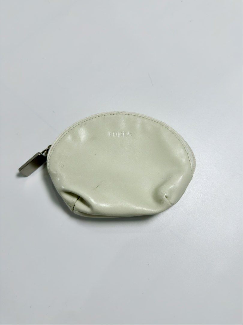 Furla Leather Coin Purse (Category: Luxury Bags & Wallets) located in Alfonso. Submitted by jbcamet (Listing ID 1458009167, Image 1). Description: - Cream colored Furla coin purse - Small and compact design - Perfect for coins or small essentials - Secure zipper closure - Genuine leather material - Shows some signs of wear, but still fully functional.