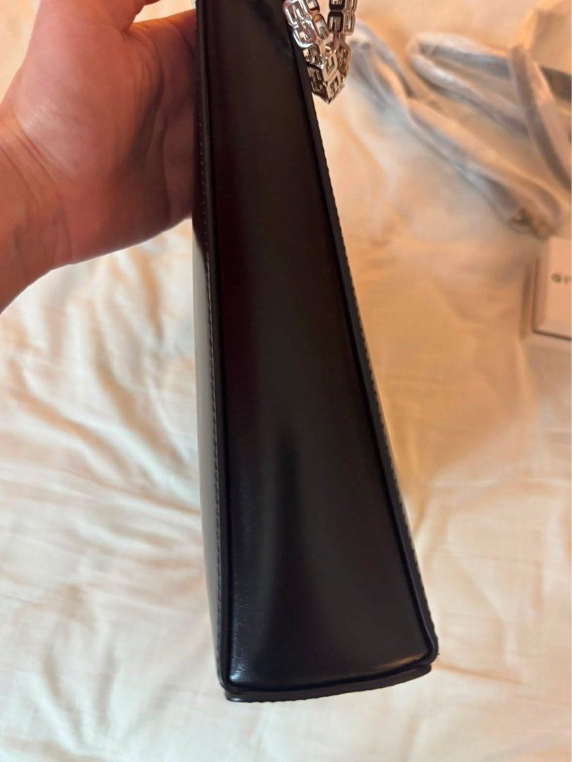 Givenchy Black Gv3 Shoulder Bag (Category: Luxury Bags & Wallets) located in Quezon City. Submitted by tinemarcelo (Listing ID 1457922421, Image 3). Description: - Authentic black Givenchy shoulder bag - Unique geometric design - Silver chain strap - Includes detachable shoulder strap - Versatile for day or night use.
