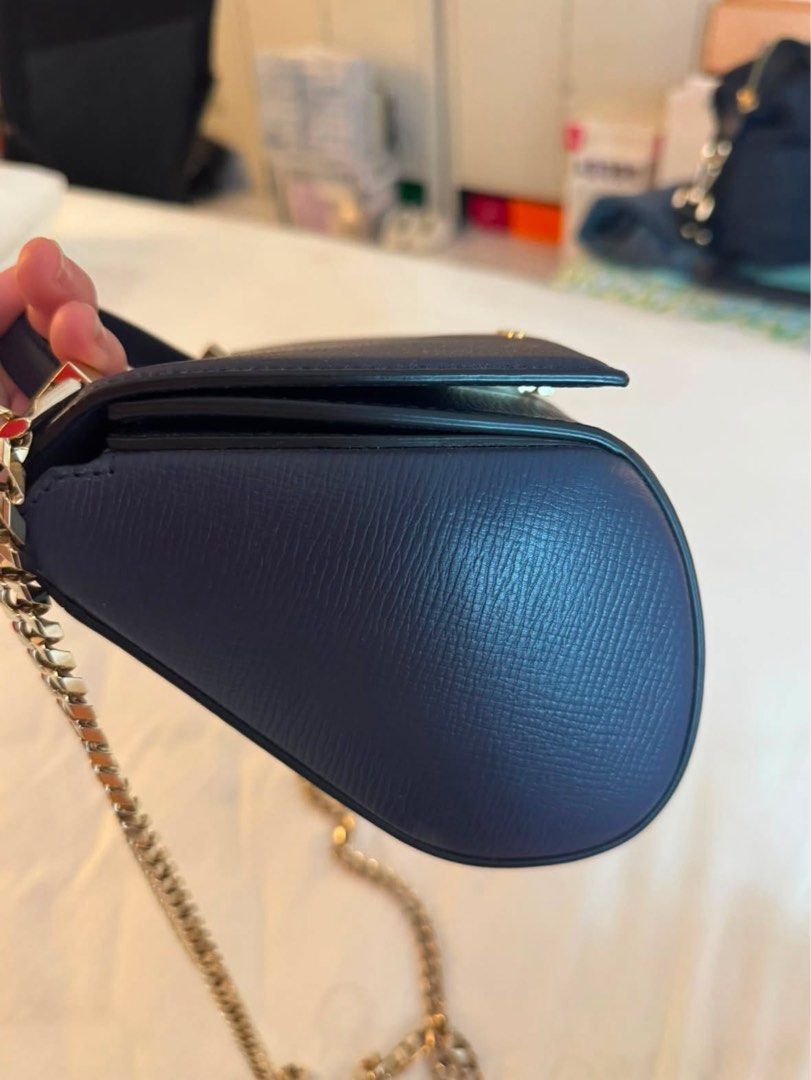 Givenchy Navy Leather Chain Shoulder Bag (Category: Luxury Bags & Wallets) located in Quezon City. Submitted by tinemarcelo (Listing ID 1457922638, Image 2). Description: - Authentic Givenchy navy blue leather handbag - Features a luxurious gold chain strap - Includes a convenient top handle - Beautiful textured leather finish - Compact size, ideal for carrying essentials - Shiny gold hardware adds a touch of elegance - Interior is clean and well