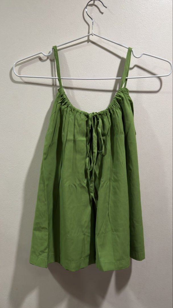 Green Cami Top with Tie Back (Category: Sleeveless) located in Cebu City. Submitted by ngl.prelovedstuff (Listing ID 1457911521, Image 2). Description: - Adorable green cami top - Adjustable spaghetti straps for a comfortable fit - Ruched neckline with elastic detail - Back tie closure for a customizable fit - Lightweight fabric, ideal for warm weather - Versatile for dressing up or down - can fit up to medium size.