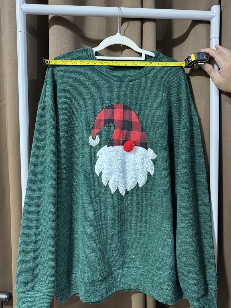 Green Christmas Gnome Sweater (Category: Coats, Jackets and Outerwear) located in Manila. Submitted by noblecrystal-c256 (Listing ID 1458049021, Image 3). Description: - Cozy green sweater perfect for Christmas! - Features an adorable gnome graphic with a red & black buffalo plaid hat and fluffy white beard. - Classic long sleeves and crew neck design. - Ideal for holiday parties or everyday casual wear. - Approximate measurements: 22 inches pit 