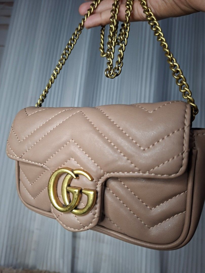 Gucci Marmont Matelassé Mini Bag Beige (Category: Luxury Bags & Wallets) located in Nabua. Submitted by alasaasche36553 (Listing ID 1458023870, Image 2). Description: FREE SF - Cute beige Gucci Marmont mini bag - Gold chain strap - Quilted leather with iconic GG logo - Adorable heart detail on the back - Minor marks on the back (please check photos).