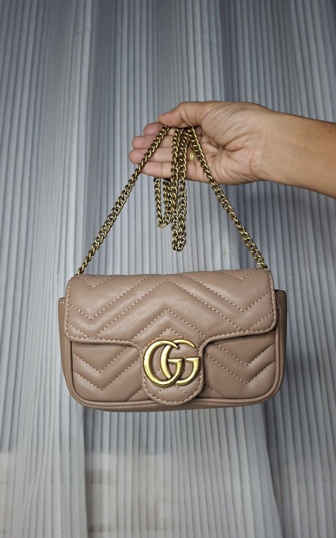Gucci Marmont Matelassé Mini Bag Beige (Category: Luxury Bags & Wallets) located in Nabua. Submitted by alasaasche36553 (Listing ID 1458023870, Image 1). Description: FREE SF - Cute beige Gucci Marmont mini bag - Gold chain strap - Quilted leather with iconic GG logo - Adorable heart detail on the back - Minor marks on the back (please check photos).