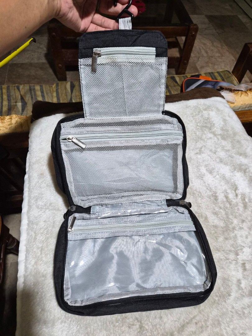 Hanging Travel Toiletry Bag Organizer (Category: Luxury Bags & Wallets) located in Mandaue City. Submitted by chuchi152615 (Listing ID 1458083114, Image 2). Description: - Black toiletry bag - Multiple compartments inside - Mesh pockets and clear zippered sections - Ideal for organizing travel essentials - Compact and easy to pack - Features a top handle for carrying - Secure zipper closure.