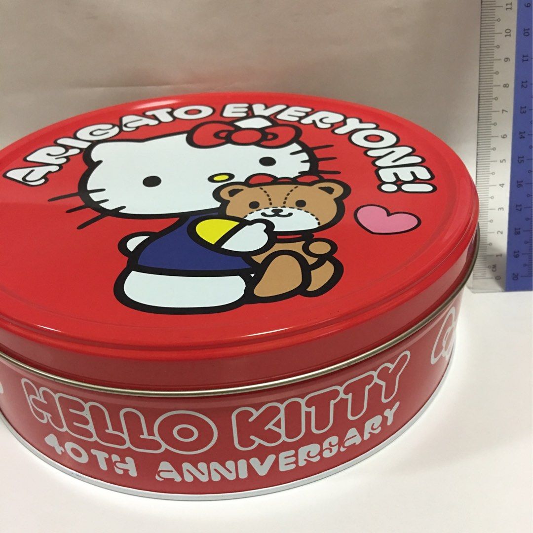 Hello Kitty Tin (Category: Food Organisation & Storage) located in Singapore. Submitted by lowpricesdeal (Listing ID 1458024752, Image 3). Description: - Kitty 40th Anniversary collectible tin - Features iconic Kitty character with a teddy bear - "Arigato Everyone!" message on the lid - Round tin design - Vibrant red exterior (pink option also available) - Ideal for storage, decoration, or gifting.