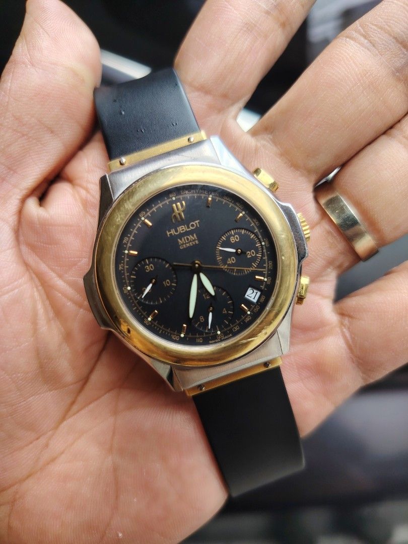 Hublot MDM Geneve Chronograph Two-Tone Watch (Category: Luxury Watches) located in Manila. Submitted by jntwatch03 (Listing ID 1458022849, Image 3). Description: - Hublot MDM Geneve Chronograph Watch - Black dial with gold accents - Tachymeter bezel - Date window - Rubber strap with a two-tone clasp - Swiss Made.