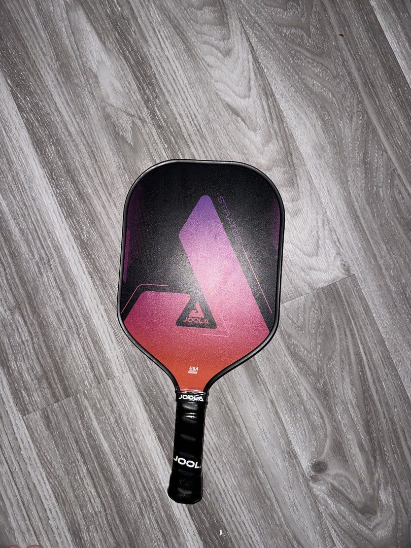 JOOLA Stratos Pickleball Paddle (Category: Racket and Ball Sports) located in Quezon City. Submitted by maxbuot1401 (Listing ID 1458063379, Image 1). Description: - JOOLA Stratos pickleball paddle - Stylish black design with pink and purple gradient - Features JOOLA branding on the handle - Perfect for your next pickleball match.