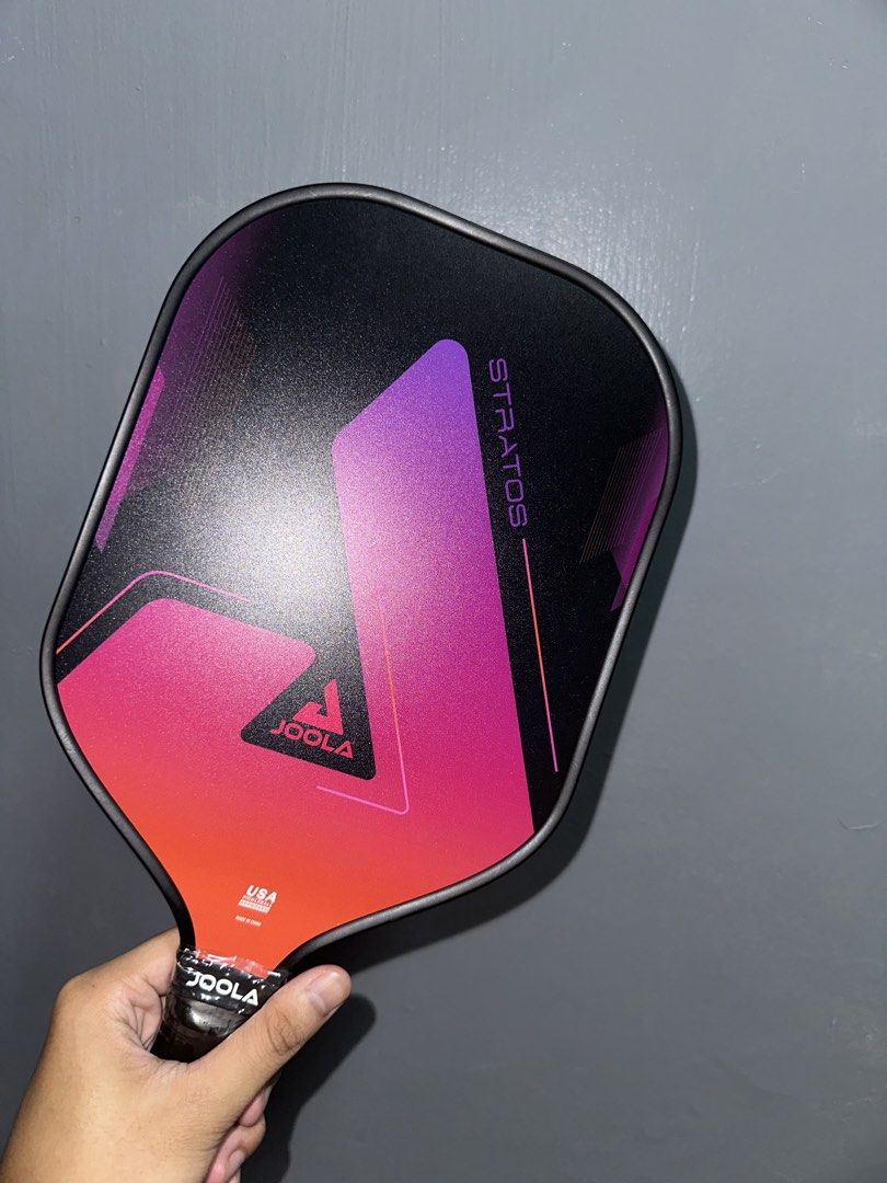 JOOLA Stratos Pickleball Paddle (Category: Racket and Ball Sports) located in Quezon City. Submitted by maxbuot1401 (Listing ID 1458063379, Image 2). Description: - JOOLA Stratos pickleball paddle - Stylish black design with pink and purple gradient - Features JOOLA branding on the handle - Perfect for your next pickleball match.