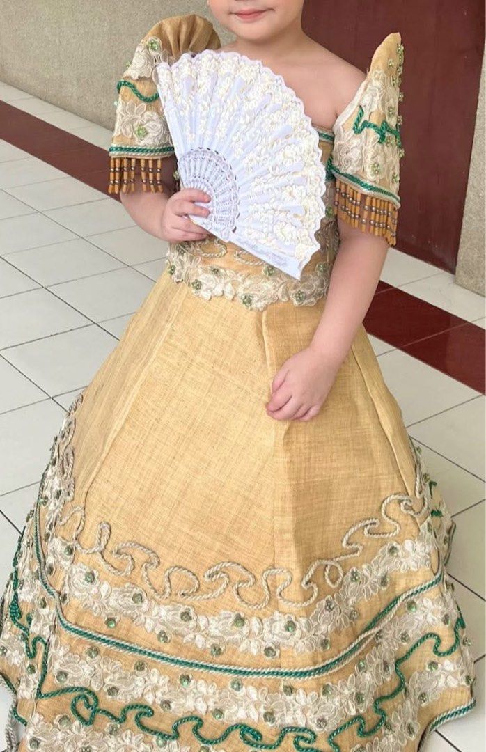 Kids Filipiniana (Category: Babies & Kids Fashion) located in Bulacan. Submitted by prelovedbycms (Listing ID 1458013319, Image 3). Description: 6-9 yrs old With peticoat For rent Beautiful yellow Filipiniana dress for kids. Features intricate beadwork and embroidery on the bodice and skirt. The sleeves have a unique design with beaded fringes. Perfect for cultural events or special occasions. The fabric has a natural texture. Comes with a pearl 