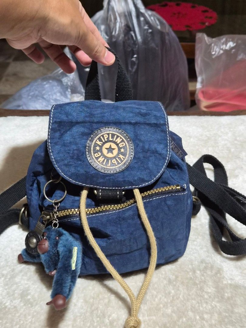 Kipling Mini Backpack in Blue with Monkey Charm (Category: Backpacks) located in Mandaue City. Submitted by chuchi152615 (Listing ID 1458084752, Image 3). Description: - Cute Kipling mini backpack - Denim blue color - Includes signature Kipling monkey charm - Drawstring and zip closure for security - Adjustable straps for comfortable wear - Small and compact, ideal for everyday use or travel.