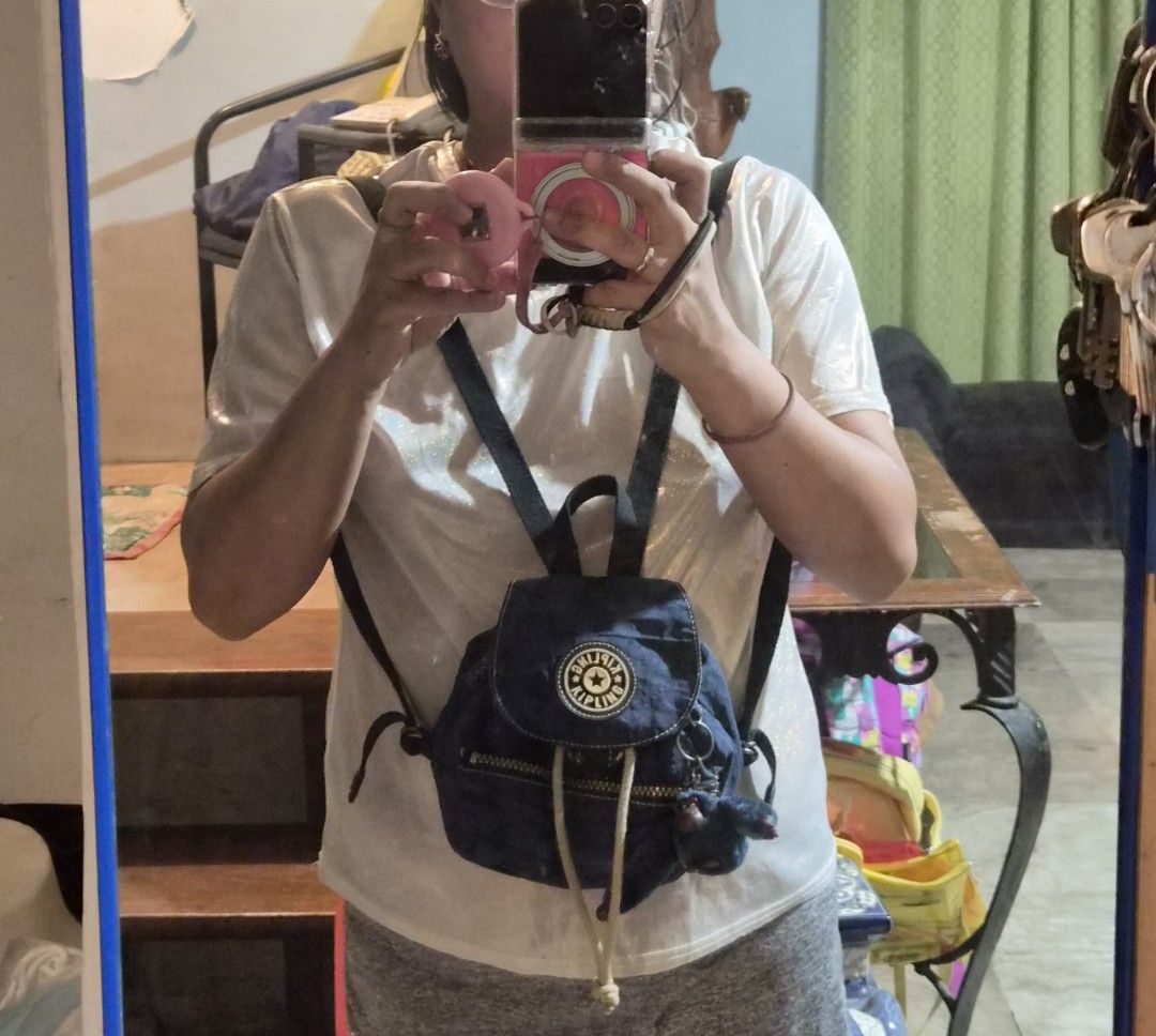 Kipling Mini Backpack in Blue with Monkey Charm (Category: Backpacks) located in Mandaue City. Submitted by chuchi152615 (Listing ID 1458084752, Image 2). Description: - Cute Kipling mini backpack - Denim blue color - Includes signature Kipling monkey charm - Drawstring and zip closure for security - Adjustable straps for comfortable wear - Small and compact, ideal for everyday use or travel.