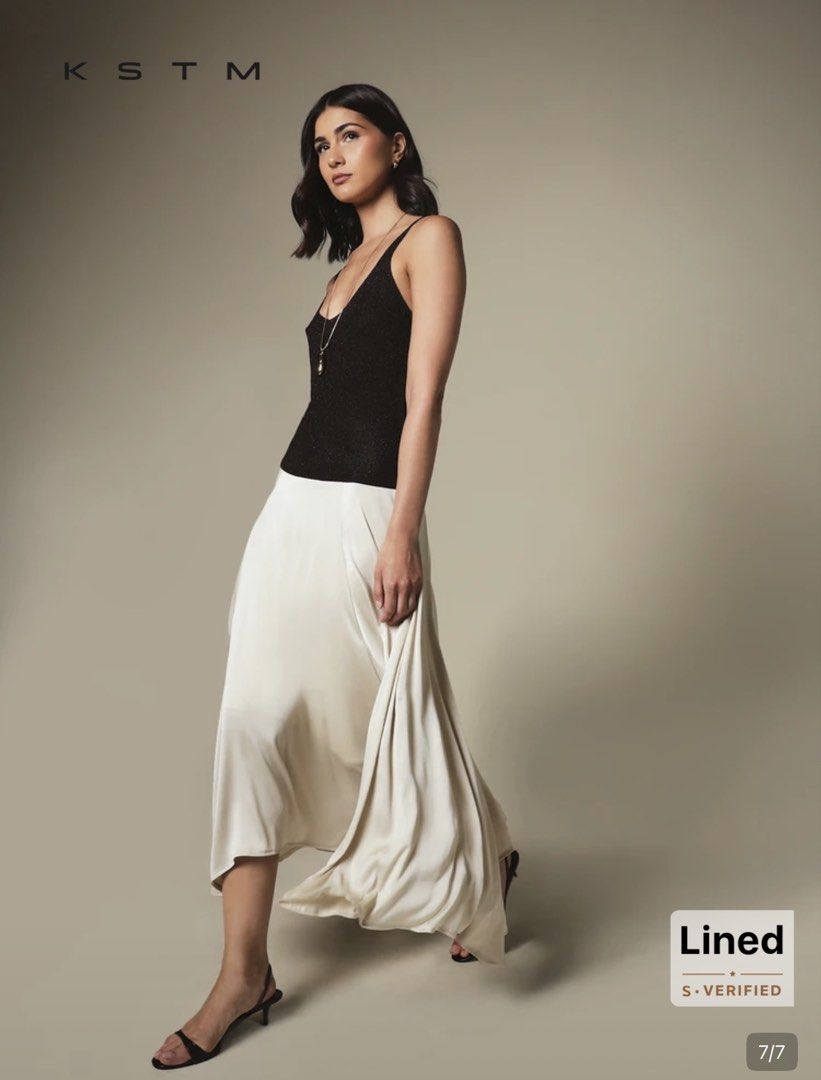 KSTM Cream Pleated Midi Skirt (Category: Skirts) located in Quezon City. Submitted by temptress (Listing ID 1458026000, Image 2). Description: VERY PRETTY, FLOWY; HIGH QUALITY - Cream midi skirt from KSTM - Features elegant pleats - Lined for a comfortable fit - Fabric has a beautiful sheen - Versatile for dressing up or down - Perfect for a sophisticated look Orig price Php 1,550 Used only once.
