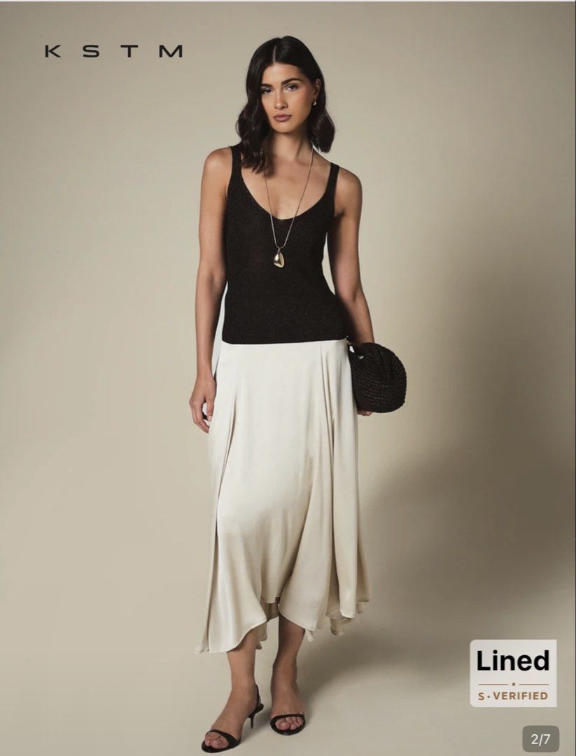 KSTM Cream Pleated Midi Skirt (Category: Skirts) located in Quezon City. Submitted by temptress (Listing ID 1458026000, Image 3). Description: VERY PRETTY, FLOWY; HIGH QUALITY - Cream midi skirt from KSTM - Features elegant pleats - Lined for a comfortable fit - Fabric has a beautiful sheen - Versatile for dressing up or down - Perfect for a sophisticated look Orig price Php 1,550 Used only once.