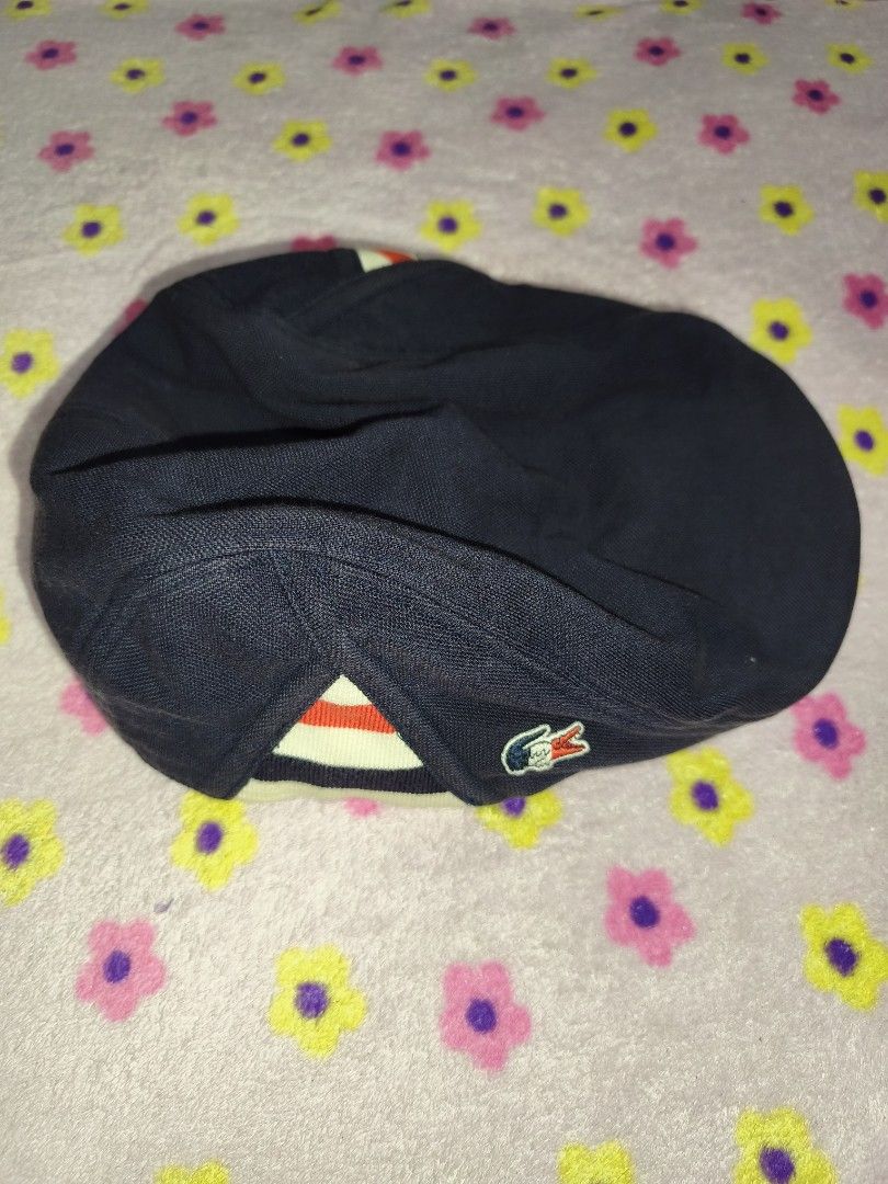Lacoste Navy Blue Flat Cap Hat (Category: Caps & Hats) located in Bulacan. Submitted by THA_D_THRIFT (Listing ID 1458072865, Image 1). Description: - Brand: Lacoste - Color: Navy Blue - Style: Flat Cap - Features: Iconic crocodile logo on the side, striped detailing on the back - Size: Free Size - Occasion: Casual wear 800 + SF.