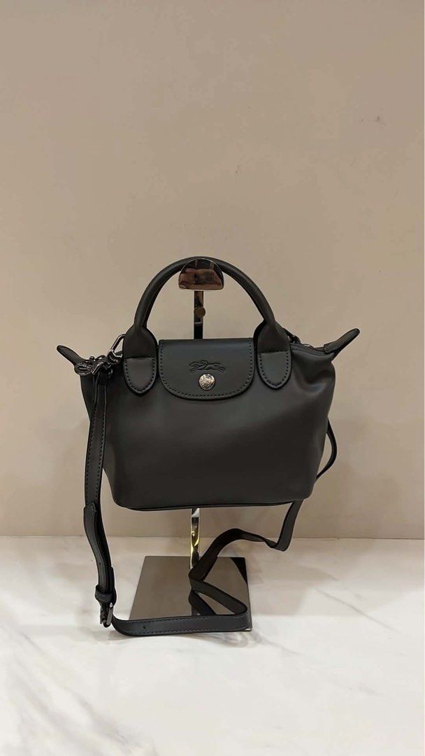 Longchamp Le Pliage Cuir Top Handle Bag (Category: Luxury Bags & Wallets) located in San Antonio. Submitted by arianeofficial (Listing ID 1457950867, Image 1). Description: - Authentic Black Longchamp Le Pliage Cuir Top Handle Bag - Made from soft, supple leather - Elegant silver hardware - Includes a detachable shoulder strap for versatile carrying - Compact size, ideal for fitting daily essentials - Perfect for everyday use or stylish travel.