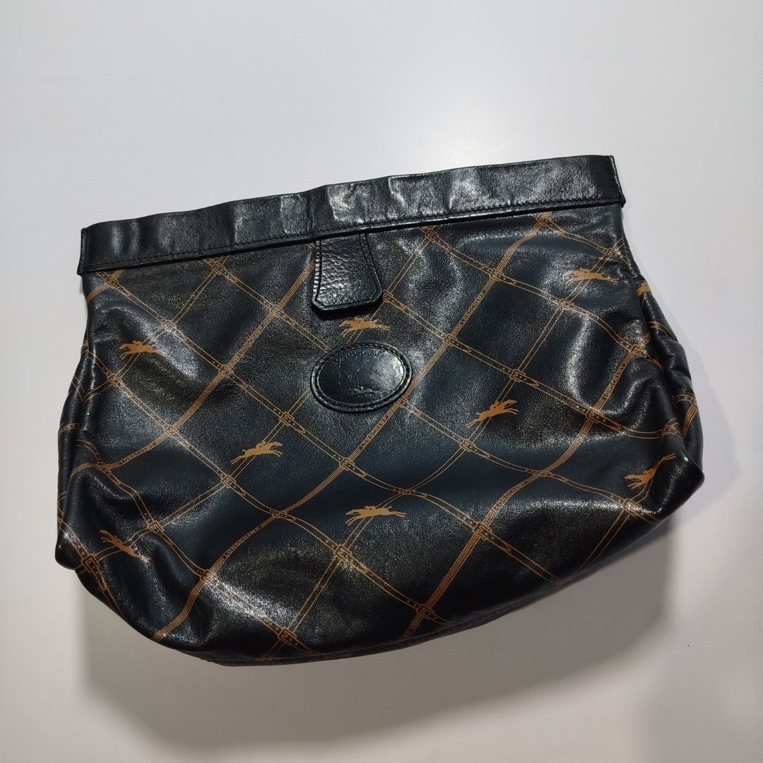 Longchamp Monogram Leather Clutch / Pouch (Category: Luxury Bags & Wallets) located in Manila. Submitted by mnlhappybattle (Listing ID 1458045597, Image 1). Description: Longchamp Monogram Leather Clutch / Pouch ​Product Description: Authentic vintage Longchamp clutch crafted in supple black textured leather featuring the brand's iconic equestrian monogram grid pattern in gold/tan tones. Classic, versatile piece ideal as a standalone clutch, cosm