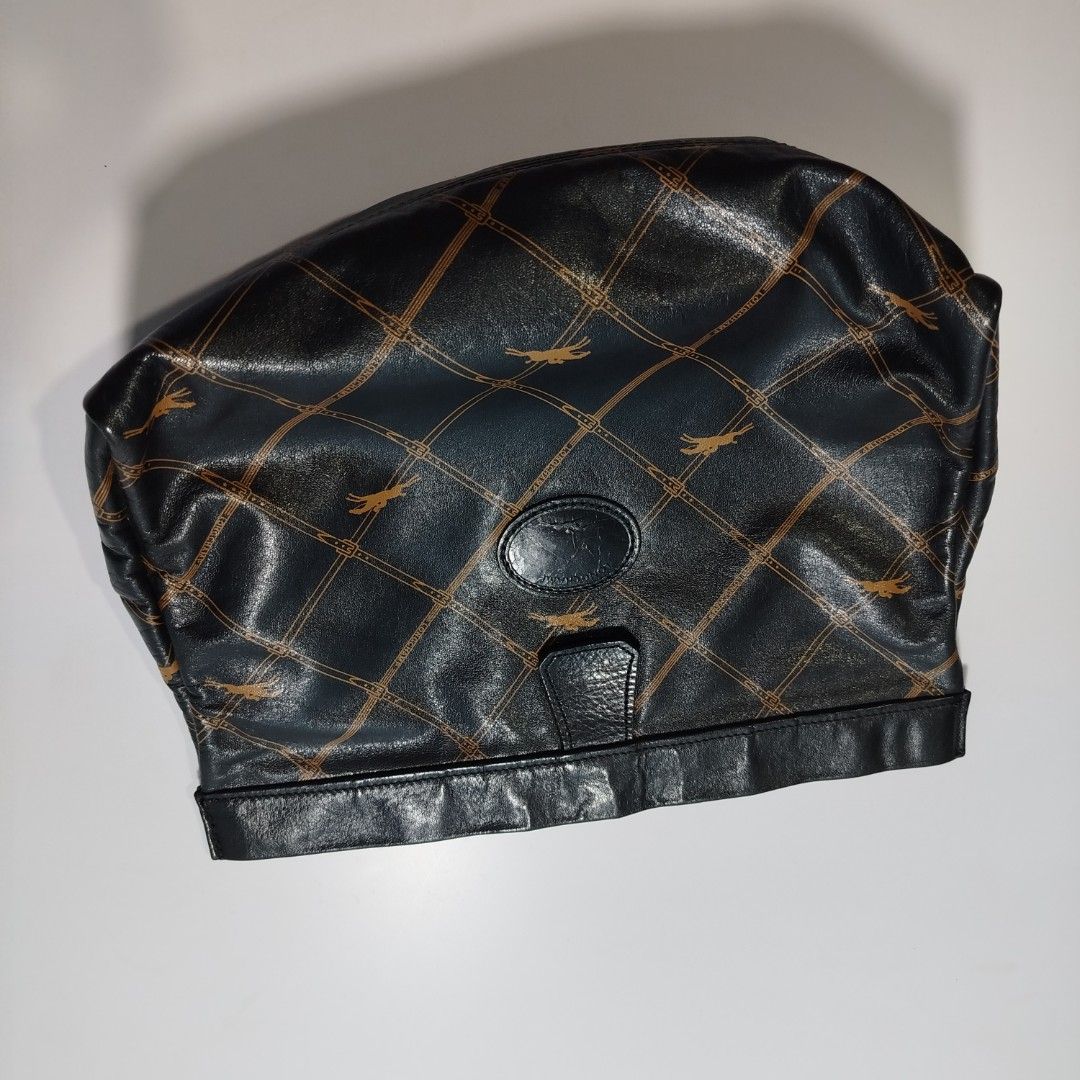 Longchamp Monogram Leather Clutch / Pouch (Category: Luxury Bags & Wallets) located in Manila. Submitted by mnlhappybattle (Listing ID 1458045597, Image 3). Description: Longchamp Monogram Leather Clutch / Pouch ​Product Description: Authentic vintage Longchamp clutch crafted in supple black textured leather featuring the brand's iconic equestrian monogram grid pattern in gold/tan tones. Classic, versatile piece ideal as a standalone clutch, cosm