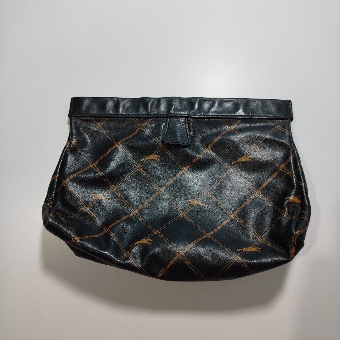 Longchamp Monogram Leather Clutch / Pouch (Category: Luxury Bags & Wallets) located in Manila. Submitted by mnlhappybattle (Listing ID 1458045597, Image 2). Description: Longchamp Monogram Leather Clutch / Pouch ​Product Description: Authentic vintage Longchamp clutch crafted in supple black textured leather featuring the brand's iconic equestrian monogram grid pattern in gold/tan tones. Classic, versatile piece ideal as a standalone clutch, cosm