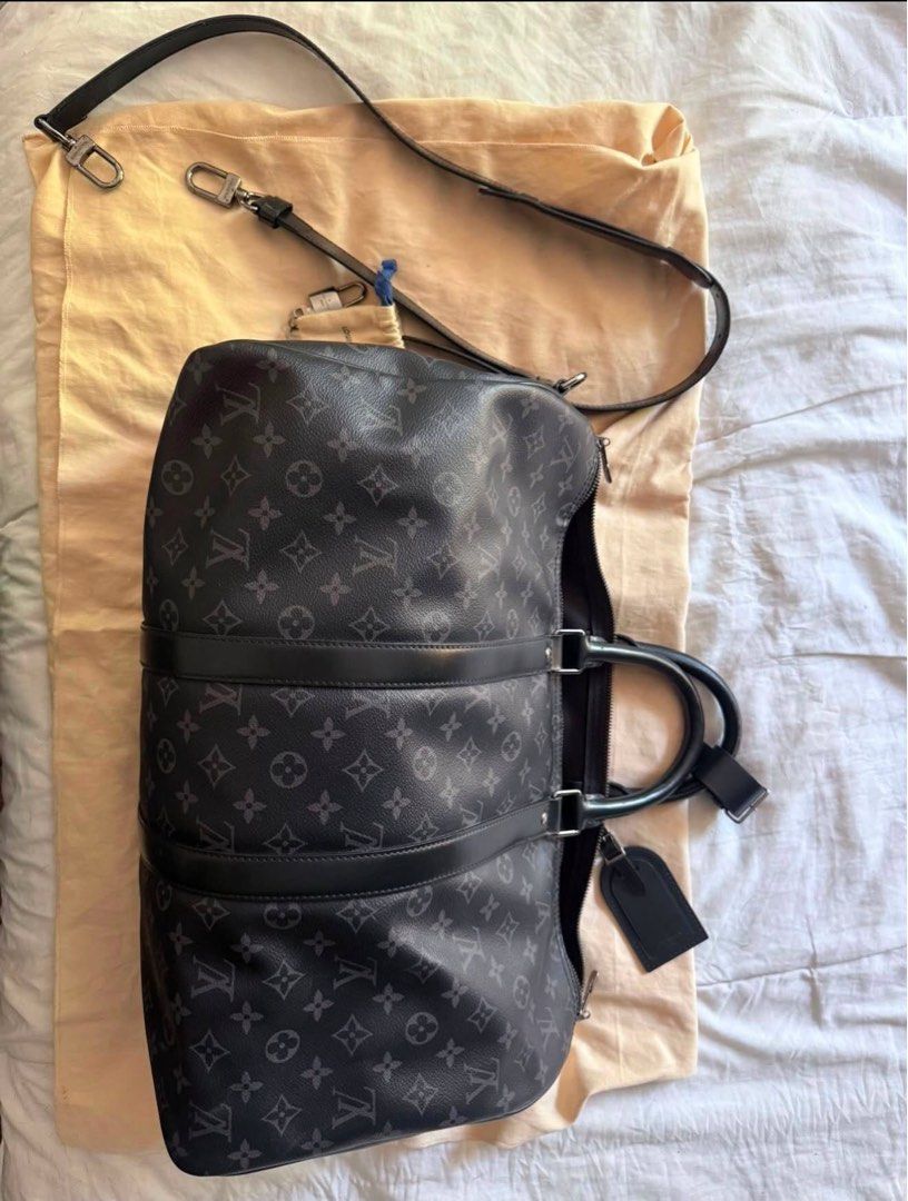 Louis Vuitton Keepall Bandouliere Monogram Eclipse 55 (Category: Luxury Bags & Wallets) located in San Pedro. Submitted by kpaniq (Listing ID 1457975729, Image 3). Description: - Authentic Louis Vuitton Keepall Bandouliere 55 - Monogram Eclipse canvas - Ideal for weekend trips or carry-on - Includes dust bag and shoulder strap - Good overall condition with some signs of wear on leather trim and handles.