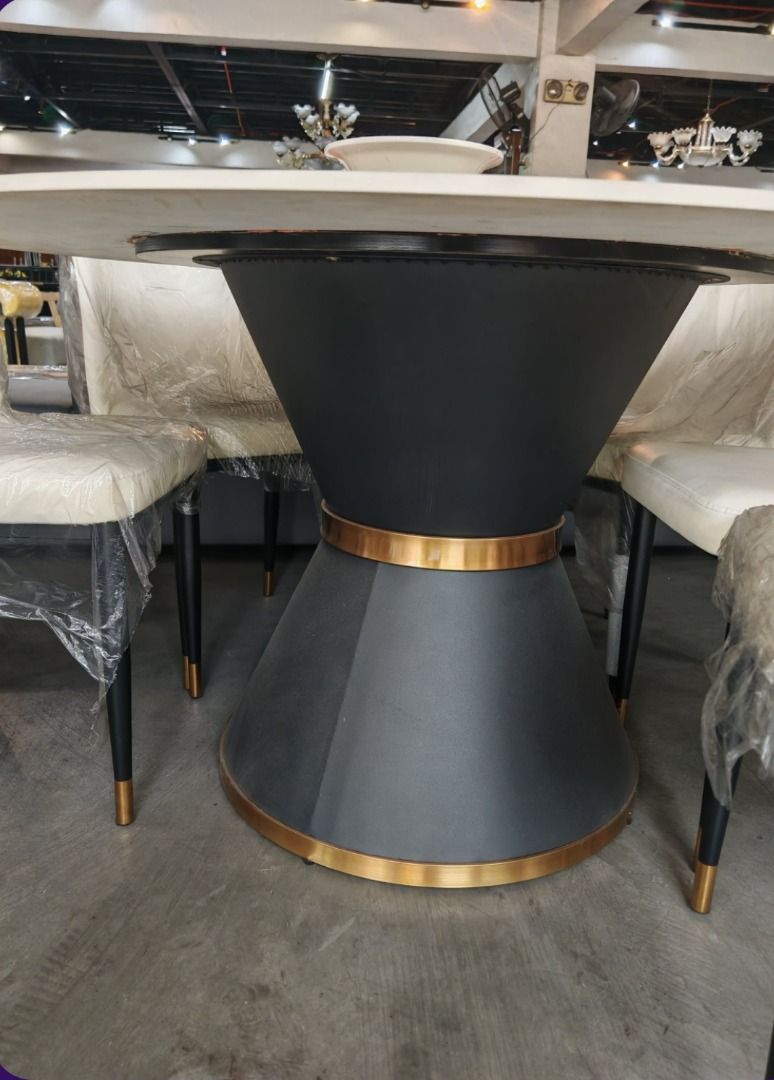 Marble Round Dining Table with 6 Chairs (Category: Tables & Sets) located in Manila. Submitted by yhel21 (Listing ID 1457971530, Image 3). Description: - Round marble dining table with built-in lazy susan - Includes 6 upholstered chairs in light cream fabric (still in original plastic wrapping!) - Stylish black table base with elegant gold accents - Ideal for family meals and hosting guests - Adds a touch of luxury to your dining space.