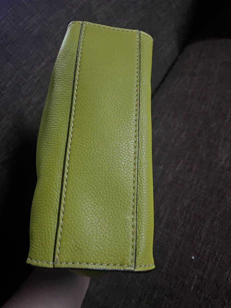 Marc Jacobs The Mini Tote Bag (Category: Luxury Bags & Wallets) located in Quezon City. Submitted by retann (Listing ID 1420354931, Image 3). Description: - Marc Jacobs mini tote bag - Olive green textured exterior - Top handle and detachable shoulder strap - Zip closure with padlock detail - Gold-tone hardware - Perfect for daily use.