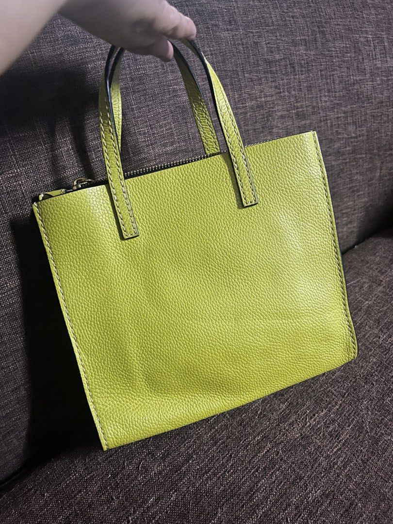 Marc Jacobs The Mini Tote Bag (Category: Luxury Bags & Wallets) located in Quezon City. Submitted by retann (Listing ID 1420354931, Image 2). Description: - Marc Jacobs mini tote bag - Olive green textured exterior - Top handle and detachable shoulder strap - Zip closure with padlock detail - Gold-tone hardware - Perfect for daily use.