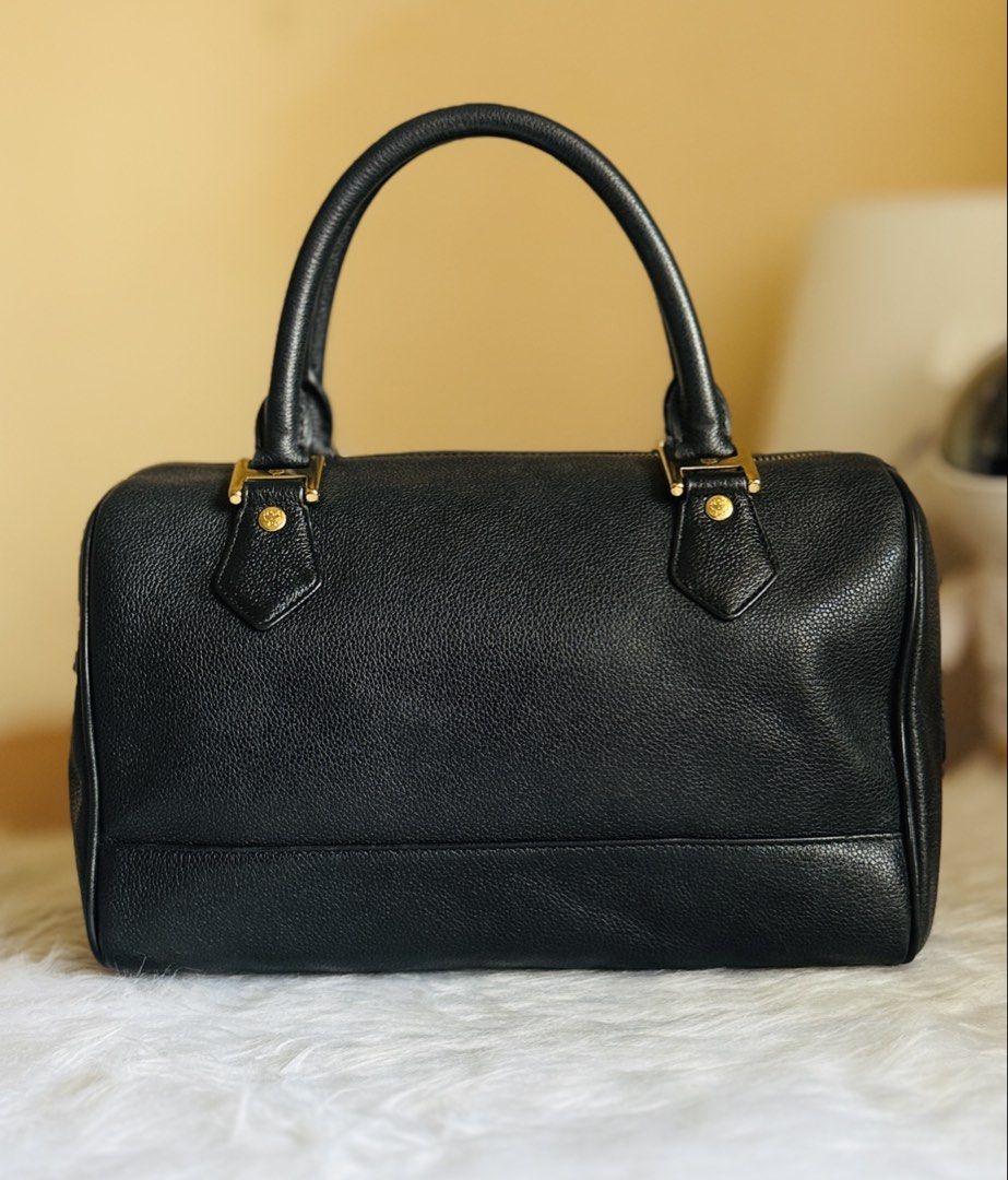 MCM Black Leather Boston Bag (Category: Luxury Bags & Wallets) located in Baguio. Submitted by vhenicekle16690 (Listing ID 1458054581, Image 2). Description: - Classic black MCM Boston bag - Textured leather with gold hardware - Iconic MCM logo plaque and studs - Top handles and zip closure - Timeless and great for daily use.