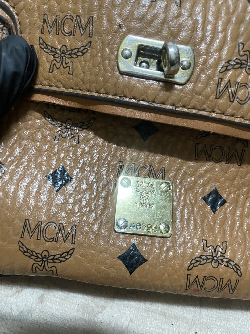 MCM cognac-colored mini satchel (Category: Luxury Bags & Wallets) located in Caloocan City. Submitted by vntgxlocalsph (Listing ID 1458062986, Image 3). Description: dents on pic.