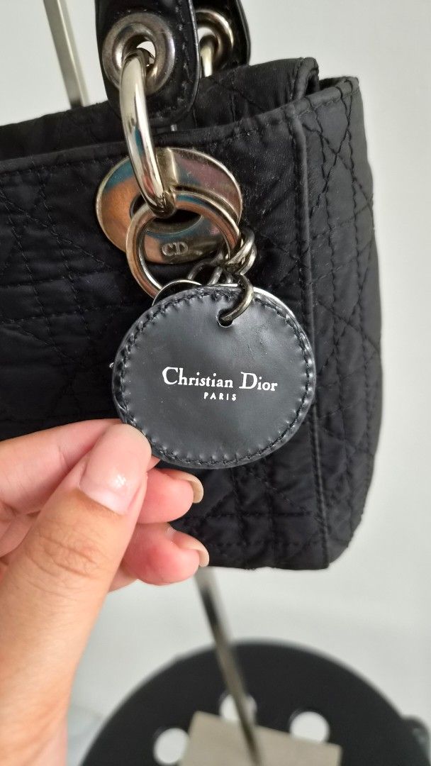 Mini Lady Dior Nylon (Category: Luxury Bags & Wallets) located in Manila. Submitted by declutterwithme__ (Listing ID 1457959595, Image 3). Description: - Authentic Christian Dior Lady Dior Bag - Color: Black - Material: Quilted Nylon - Features: Iconic Dior Charms, Patent Leather Handle - Interior: Clean - Hardware: Shows some signs of wear - Condition: Classic piece, well-loved - Inclusion: original strap please note bag is vintage style Price i