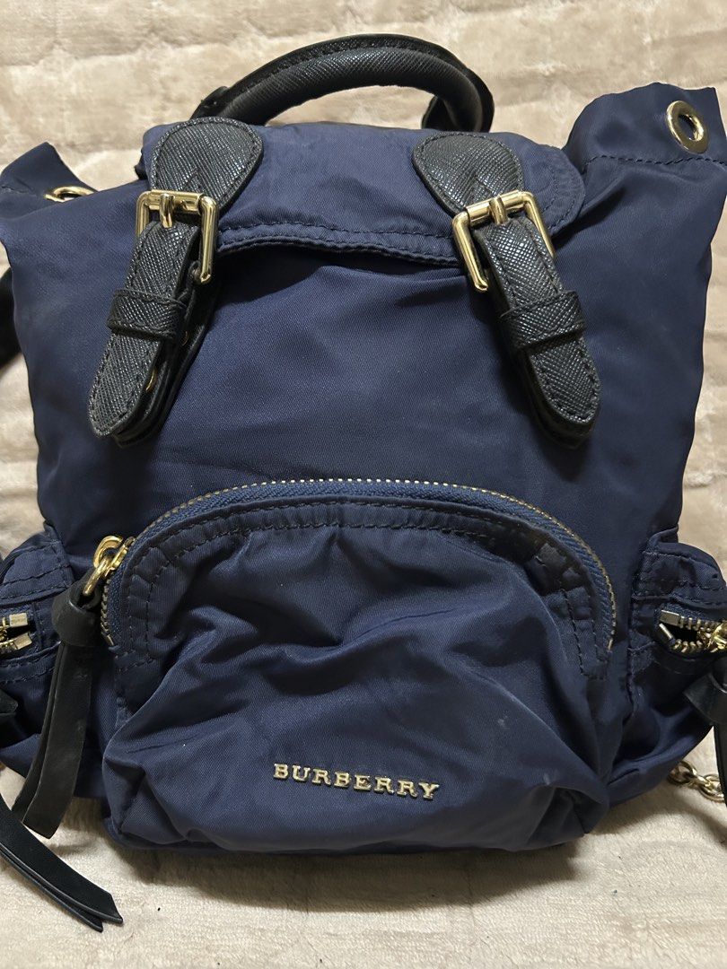 navy blue Burberry nylon backpack (Category: Luxury Bags & Wallets) located in Caloocan City. Submitted by j3ngsanity (Listing ID 1458057816, Image 2). Description: dents on pic.