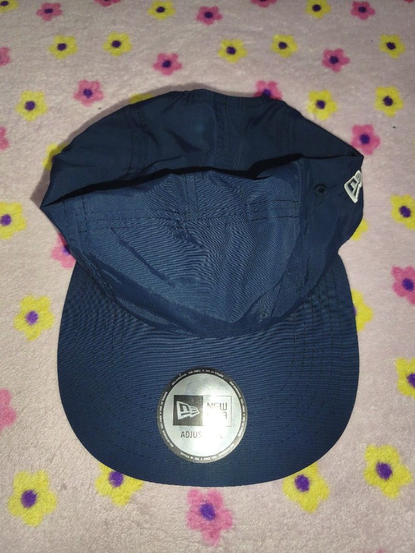 New Era Navy Blue 5-Panel Adjustable Cap (Category: Caps & Hats) located in Bulacan. Submitted by THA_D_THRIFT (Listing ID 1458072195, Image 1). Description: - Brand: New Era - Color: Navy Blue - Design: 5-panel - Closure: Adjustable strap at the back - Material: 100% Nylon - Sizing: One size fits most - Style: Simple, classic, great for everyday wear 1250 + SF.