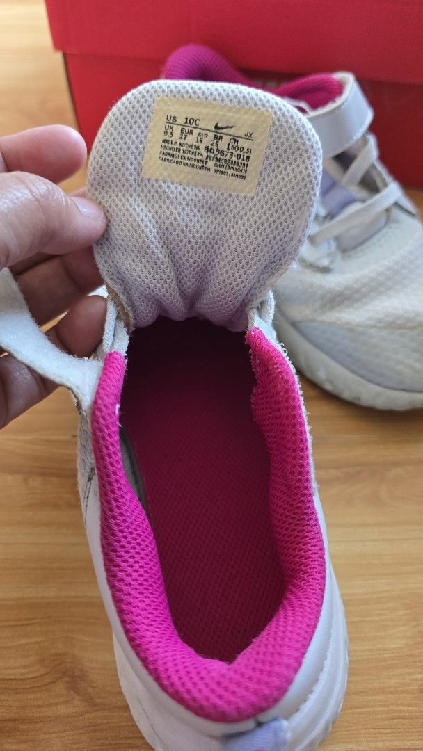 Nike Kids' Sneakers (Category: Babies & Kids Fashion) located in Quezon City. Submitted by impdc1130 (Listing ID 1458080935, Image 3). Description: Light grey Nike kids' sneakers, size 10C. Features pink lining and purple swoosh..