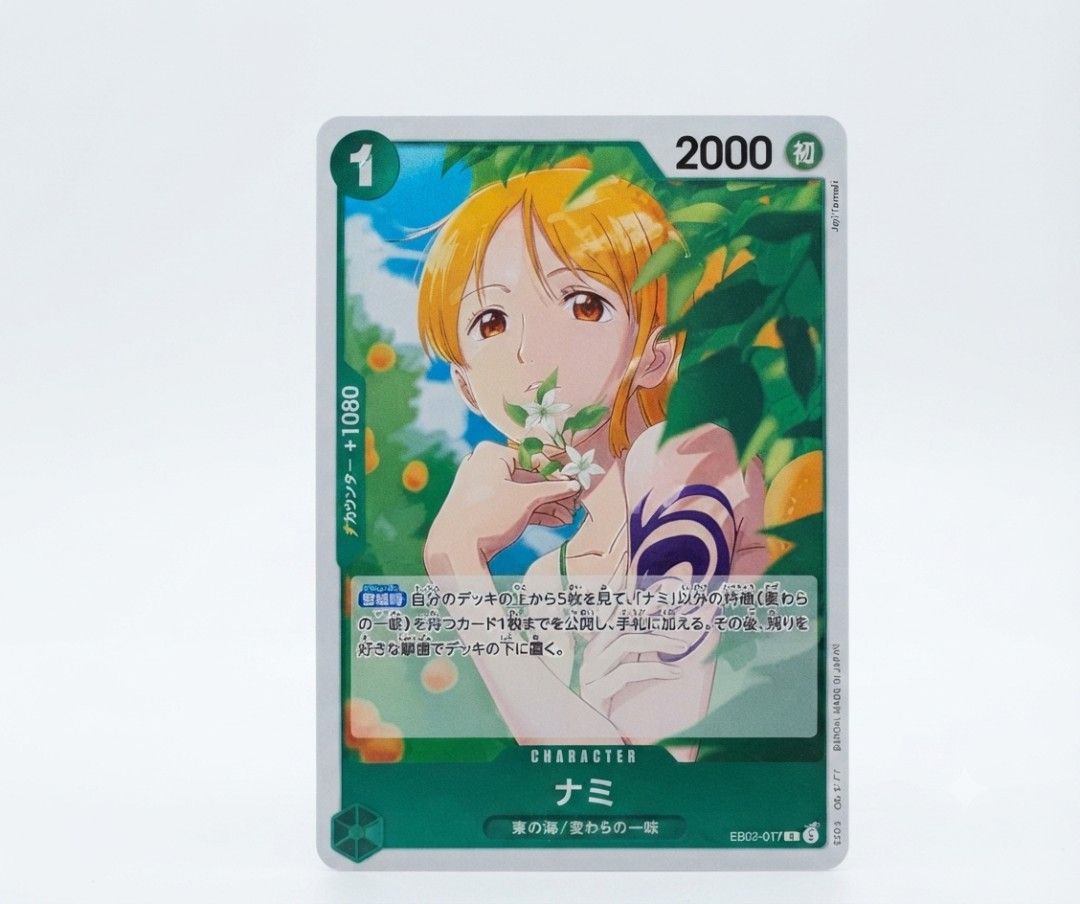 One Piece Nami - (EB02-017) (Category: Raw Singles) located in Pasig City. Submitted by moguritheracoon (Listing ID 1458038961, Image 2). Description: - Official One Piece Card Game Card: Nami (EB02-017) - Power: 2000 - Counter: +1080 - Effect: Look at the top 5 cards of your deck, add 1 'Nami' or 'Weather Egg' card to your hand, and place the rest at the bottom of your deck. - Perfect for collectors and Nami fans!.